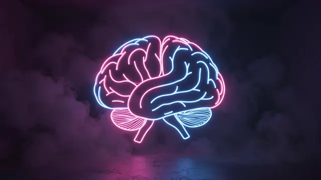 A pink and blue neon tube brain floats above a reflective floor in a dark foggy room