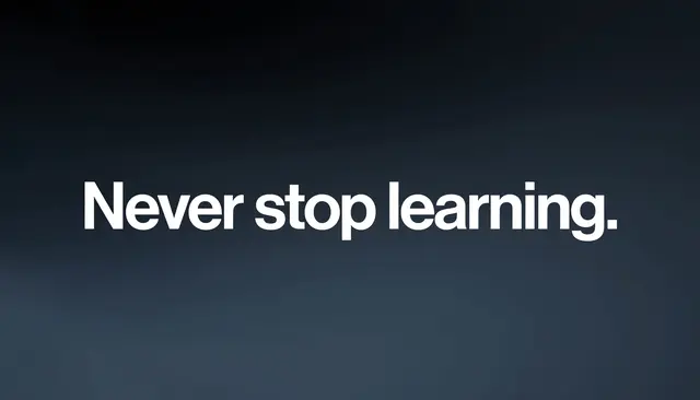 Bold white text reading "Never stop learning." centered on a dark slate gradient desktop wallpaper