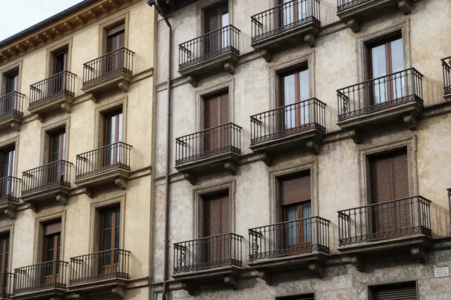 Close-up view of adjacent old European apartment buildings with wrought iron balconies