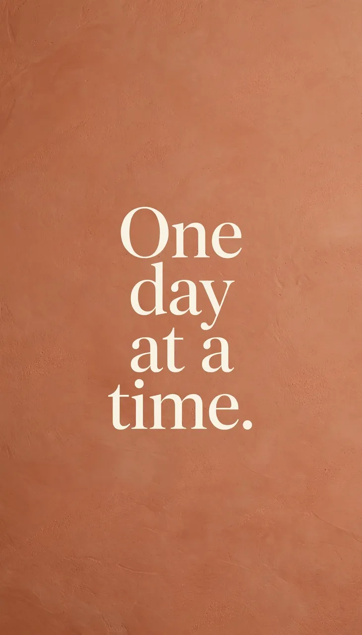 Cream serif text reading "One day at a time." centered on a warm terracotta textured vertical phone wallpaper background.