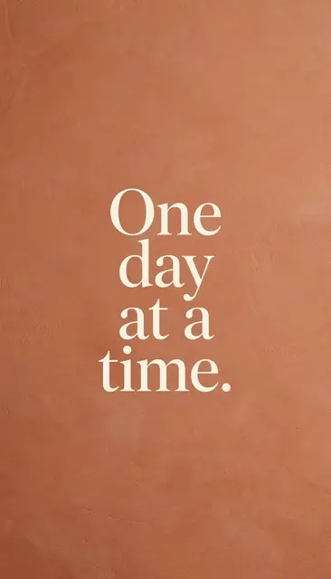 Cream serif text reading "One day at a time." centered on a warm terracotta textured vertical phone wallpaper background.