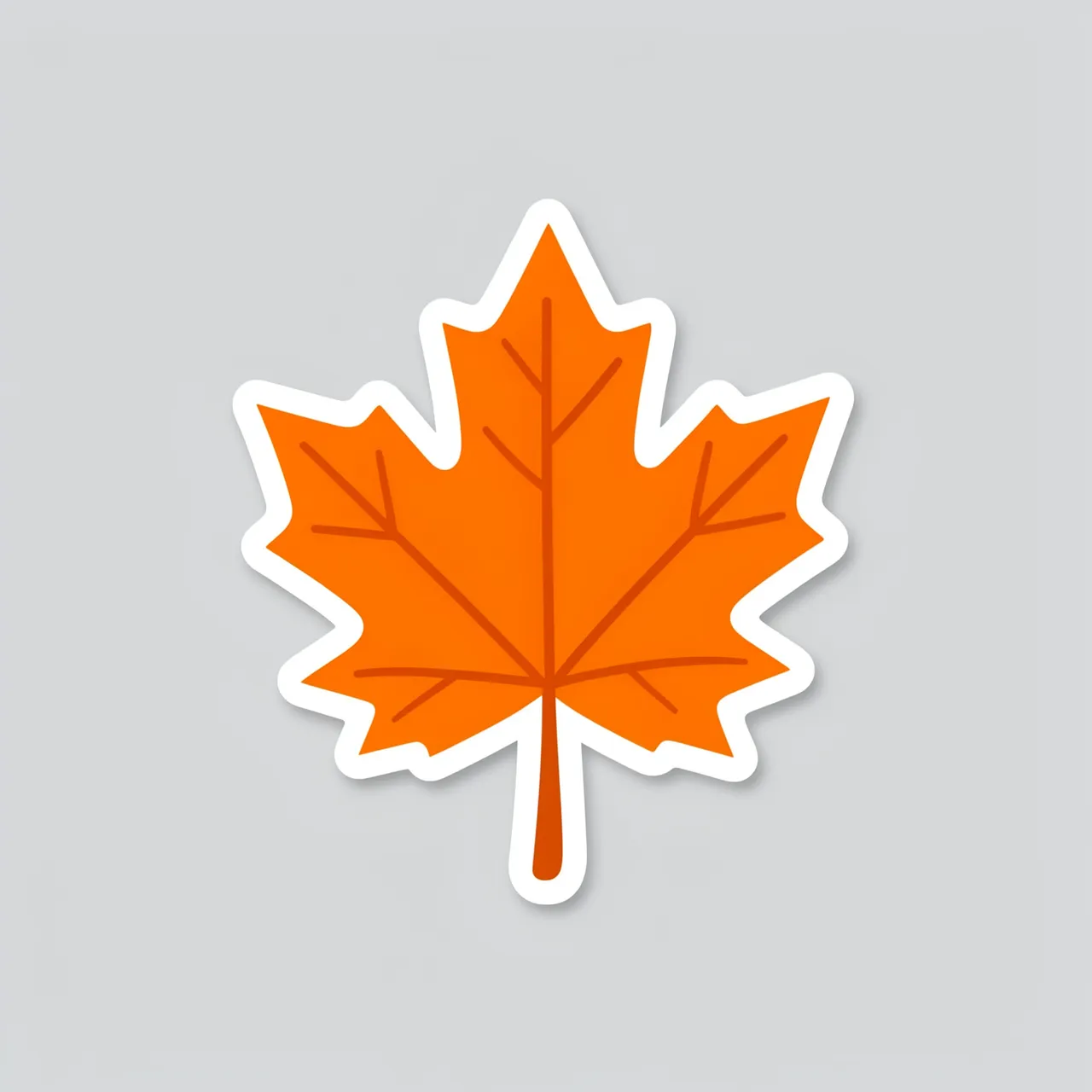 A flat die-cut sticker of an orange maple leaf with a white border rests on a light gray background