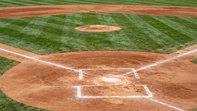 High-angle view of a freshly marked baseball field with groomed grass, dirt infield and crisp chalk lines.