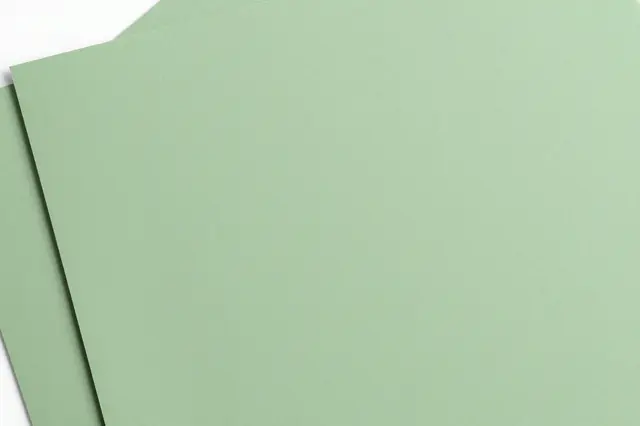 Two overlapping matte sage green paper sheets with a soft diagonal shadow line on a plain background