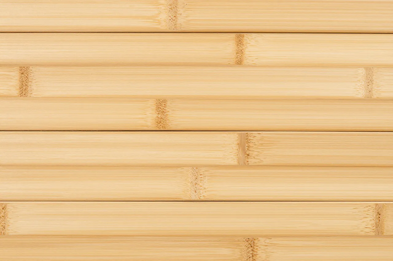 Full frame close up of horizontal pale bamboo planks showing distinct natural nodes and grain