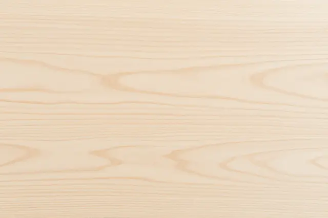 Full frame top view of pale rotary cut birch plywood with soft swirling wood grain