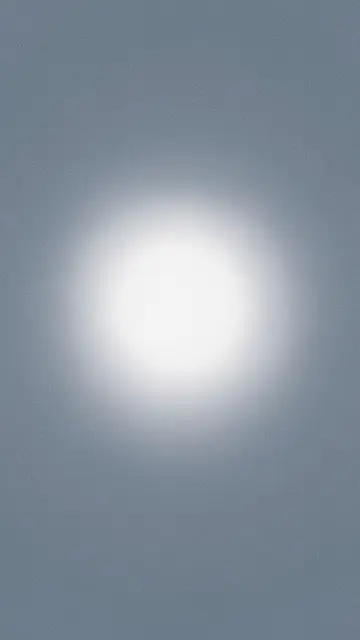 A grainy slate blue-gray vertical gradient with a soft glowing pale white halo centered in the frame