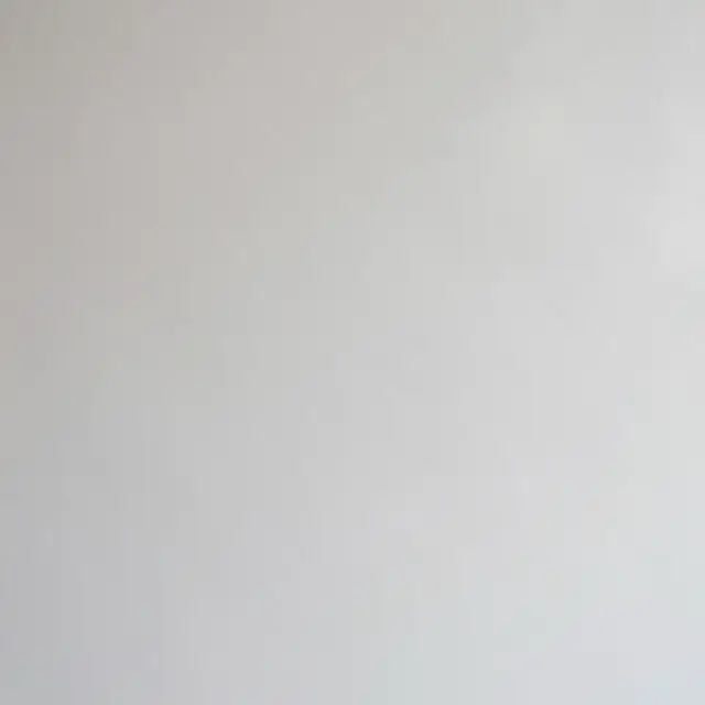 Full frame close-up of polished pale gray marble dust plaster with a soft satin sheen under even light