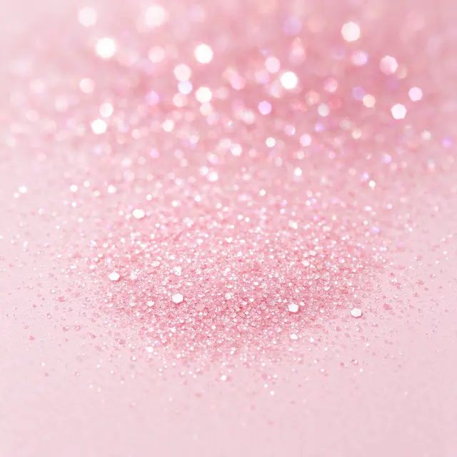 Fine pale pink glitter with soft sparkling bokeh across the top of the frame