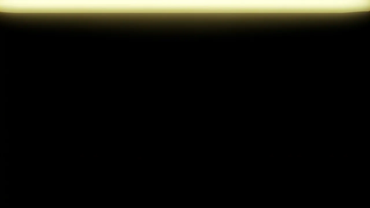 A pure black background with a soft faint pale yellow light leak running along the top edge