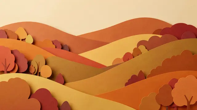 Layered paper cut art of rolling autumn hills dotted with stylized trees in warm fall tones