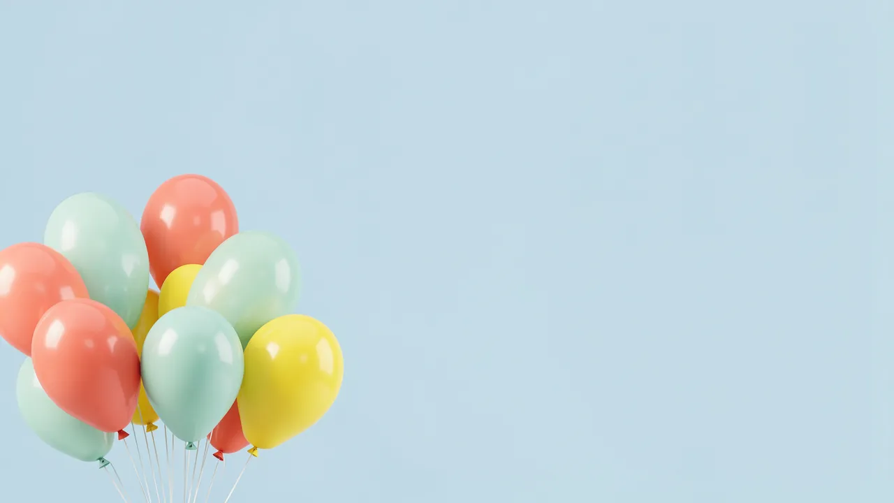 Bunch of glossy coral, mint and lemon balloons sits in the lower left against a pale blue empty background