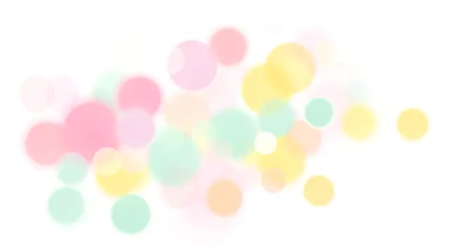 Soft overlapping pastel pink, mint and yellow bokeh circles scattered across a clean white backdrop