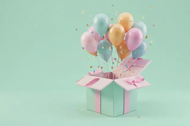 An open mint gift box releases pastel balloons and confetti against a solid mint background with empty left copy space.