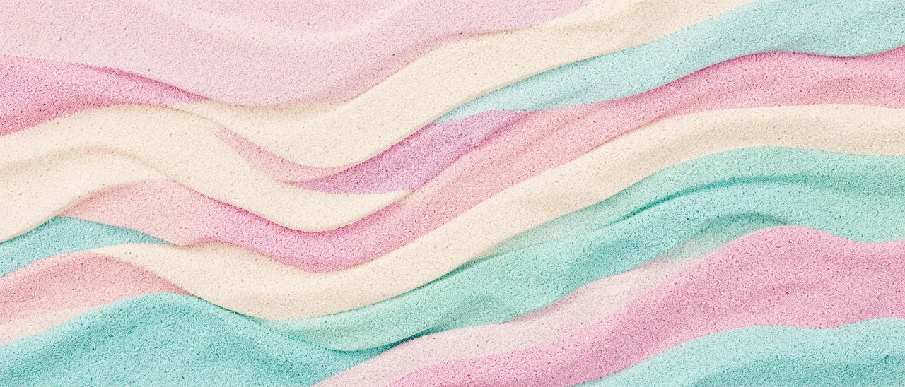 Curved wavy bands of fine granular pastel sand in pink, cream, and turquoise fill the full ultrawide frame