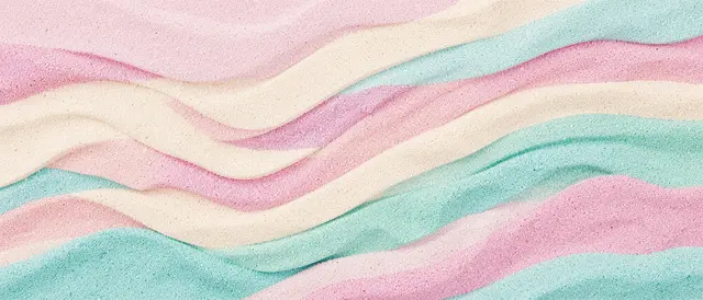 Curved wavy bands of fine granular pastel sand in pink, cream, and turquoise fill the full ultrawide frame