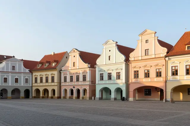 Empty cobblestone old town square lined with pastel historic buildings under soft sunrise sky