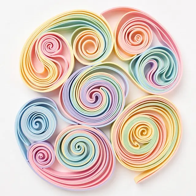 Intricate rolled pastel paper quilling swirls arranged on a plain off-white background