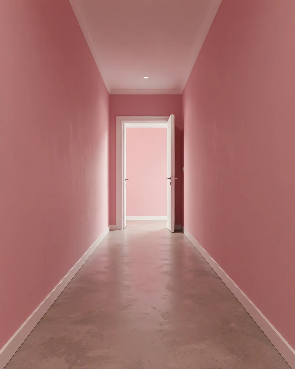A long empty pink walled hallway leads to an open white door at the far end