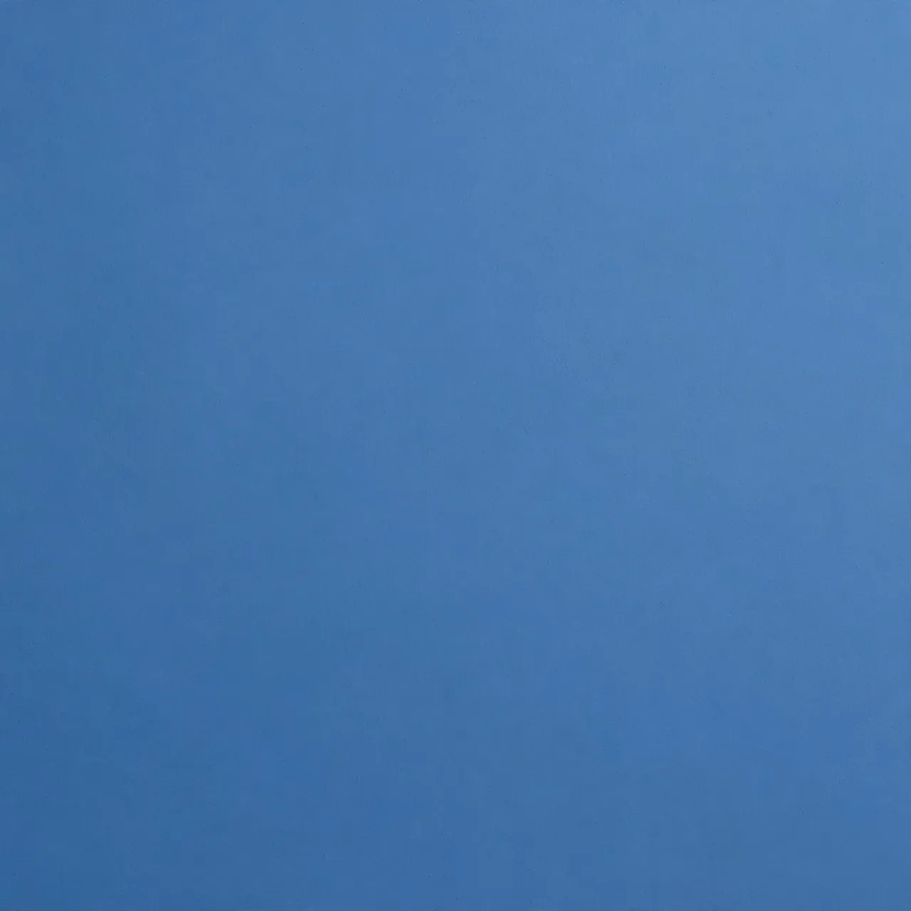 Uniform smooth even-toned medium blue flat surface with no additional details