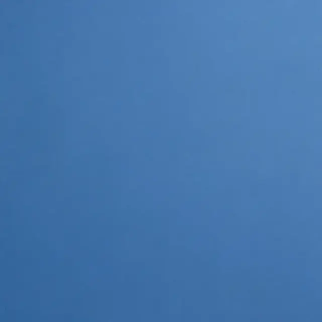 Uniform smooth even-toned medium blue flat surface with no additional details