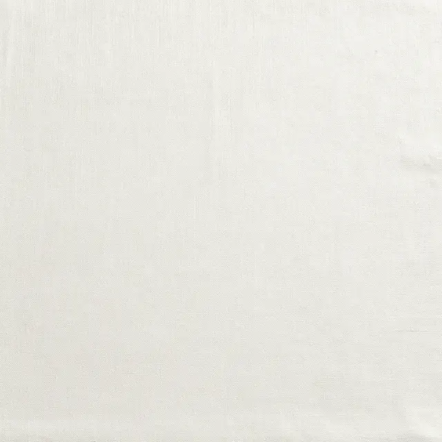 Full frame close-up of tight woven bleached white linen fabric with even soft lighting