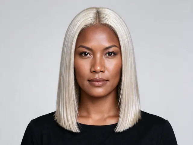 Studio headshot of a Pacific Islander woman in her thirties with a blunt platinum blonde collarbone cut and black top