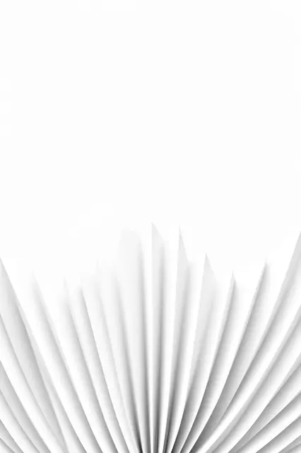 Fan-folded white 3D paper pleats sit along the bottom of the frame with empty plain white space above.