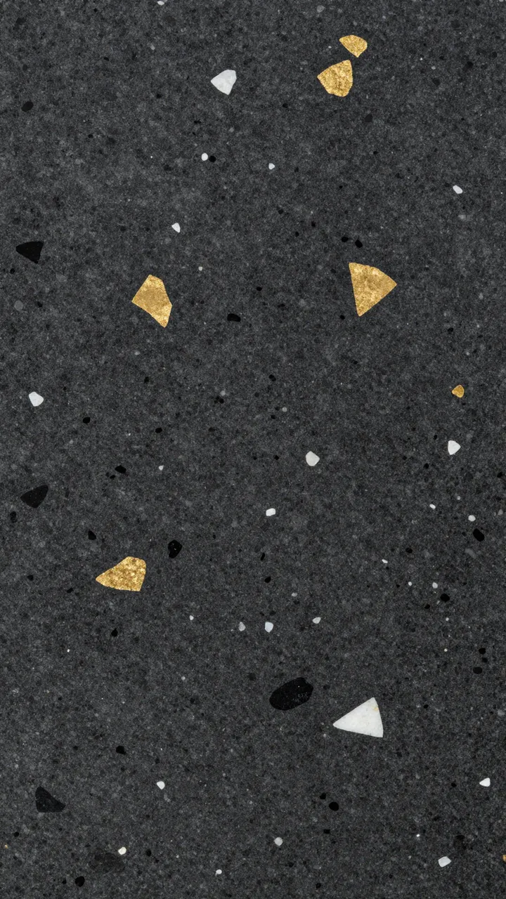 Close-up of polished black terrazzo embedded with irregular gold, white, and black stone fragments