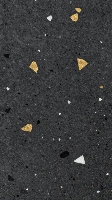 Close-up of polished black terrazzo embedded with irregular gold, white, and black stone fragments