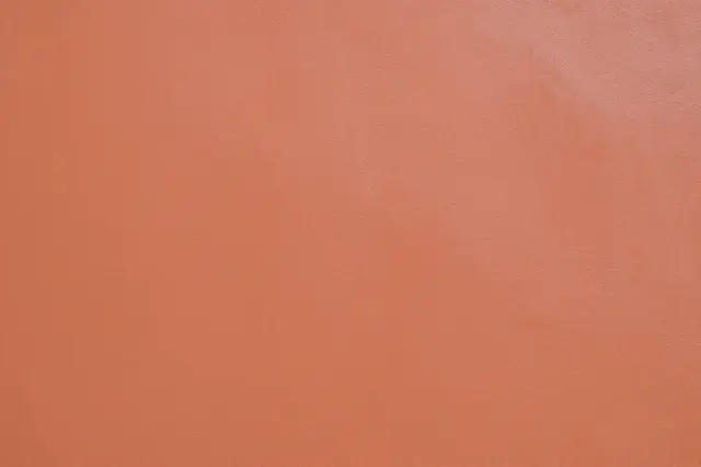 Full frame close-up of soft terracotta venetian plaster with a subtle polished sheen
