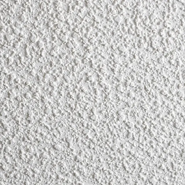 Full frame close-up of rough, white sprayed popcorn ceiling acoustic texture with even lighting