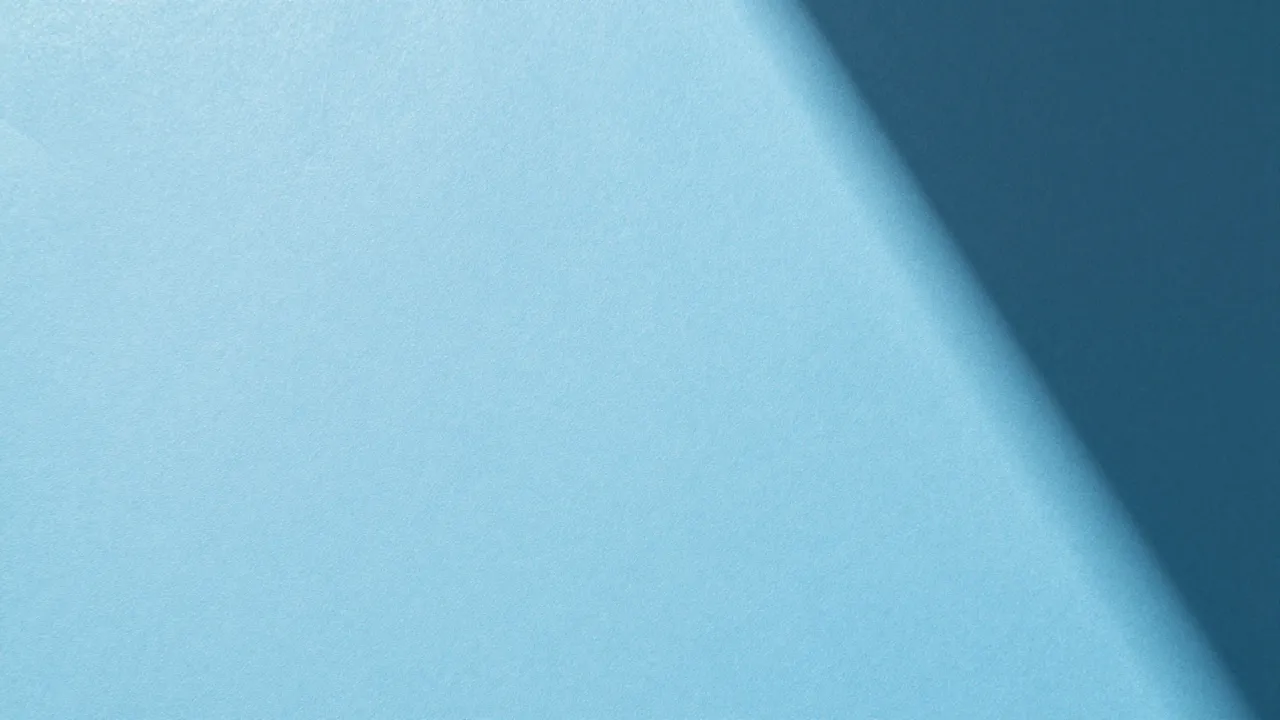 Textured powder blue paper backdrop with a soft diagonal curved gradient shadow.