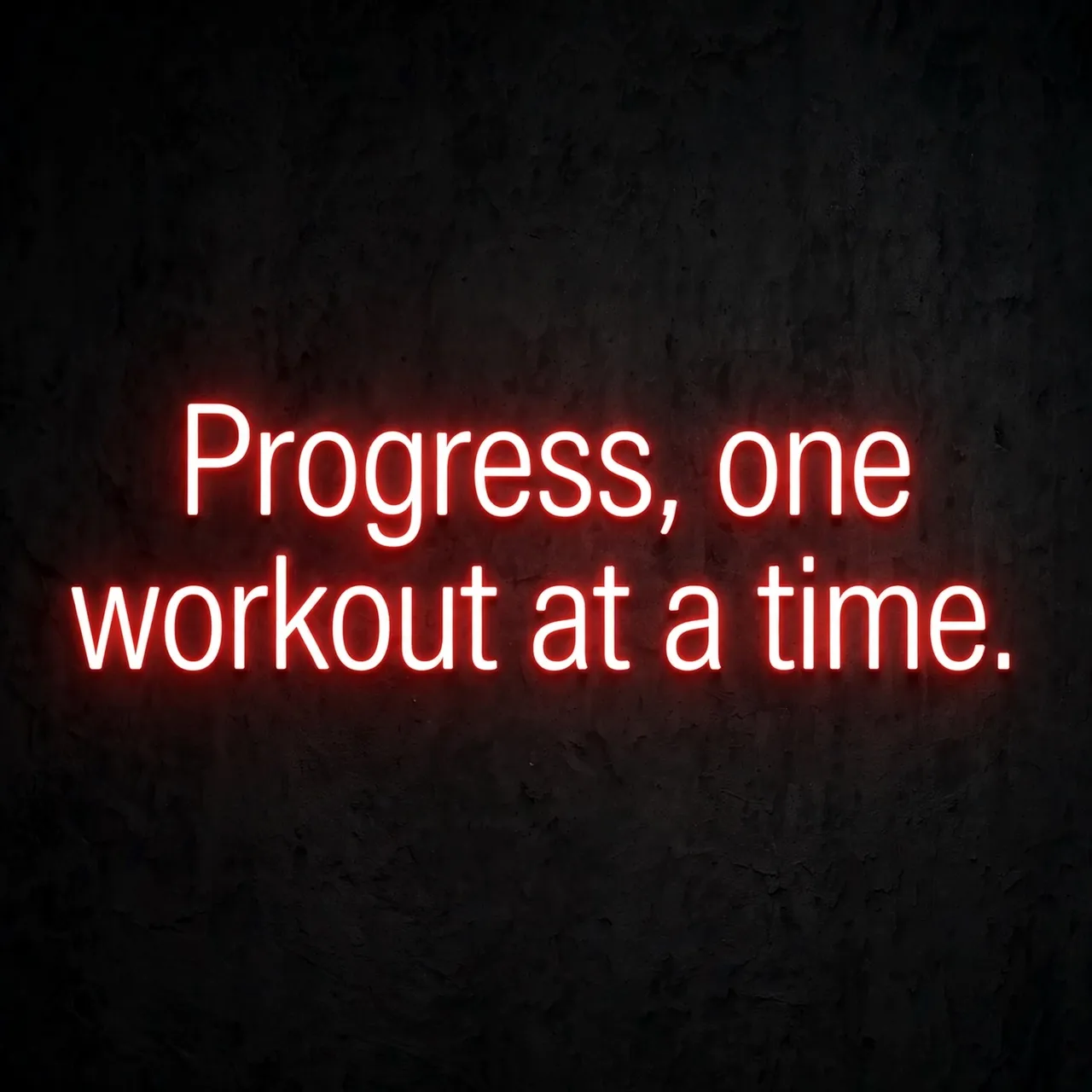 Glowing red neon sign displaying the quote "Progress, one workout at a time." on a dark textured gym wall
