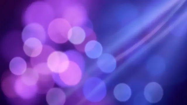 Soft blurred purple and blue bokeh orbs with diagonal glowing light streaks against a dark gradient background
