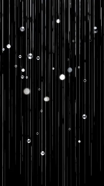Vertical rain streaks and bright reflective round droplets appear against a solid pure black background