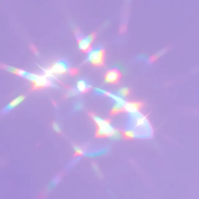 Iridescent rainbow lens flare sparkles scattered across a soft lilac background