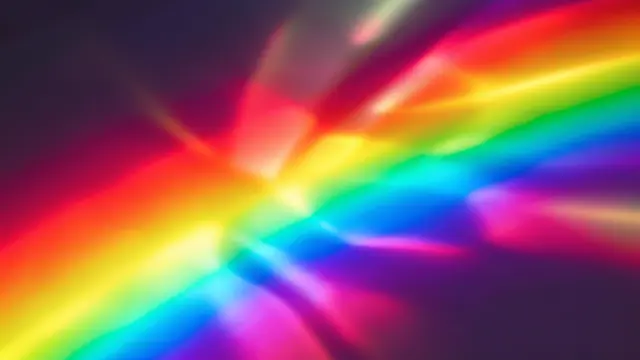 Blurred diagonal rainbow light refraction streaks glow against a dark deep purple background