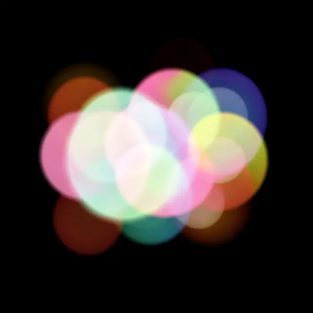 Overlapping soft translucent pastel rainbow bokeh circles cluster against a solid pure black background