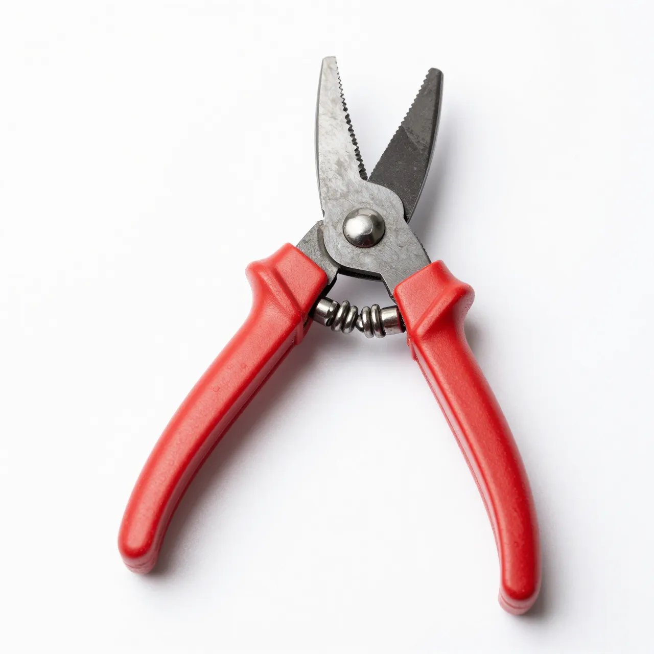 Open bypass pruning shears with red handles resting on a plain white background