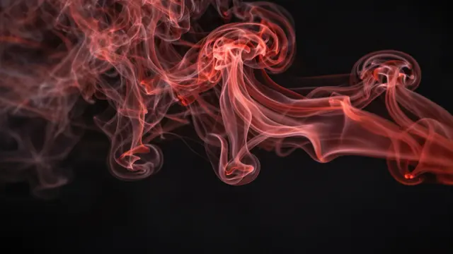 Wispy swirling red smoke billows across a solid dark black background