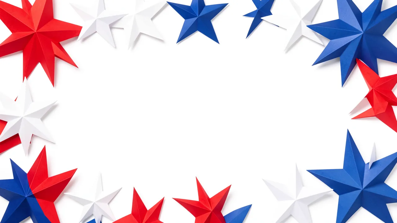 Folded red, white and blue paper stars arranged in a border around empty white copy space on a plain white background