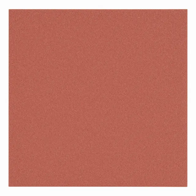 A full frame close-up of coarse reddish-brown sandpaper grit under even flat lighting