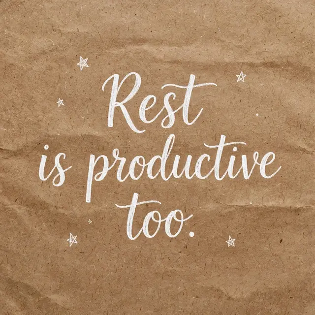 White hand lettering reading "Rest is productive too." with small doodled stars on crumpled brown kraft paper
