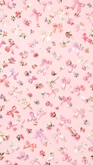 Scattered satin ribbon bows and tiny delicate flowers arranged across a soft pale pink background