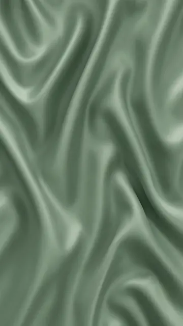 Vertical full frame of rippling sage green silk with soft flowing highlights and folds