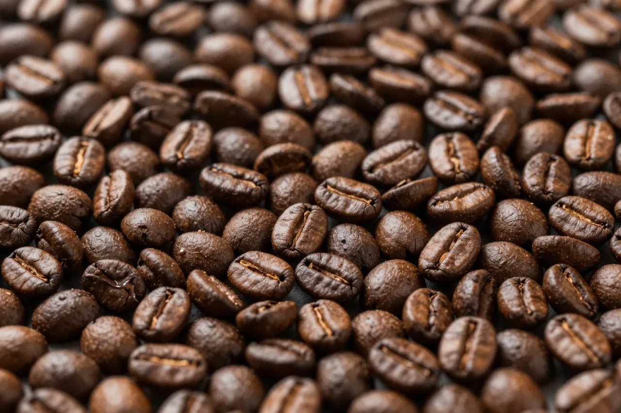Full frame top view of densely packed roasted coffee beans with soft natural lighting