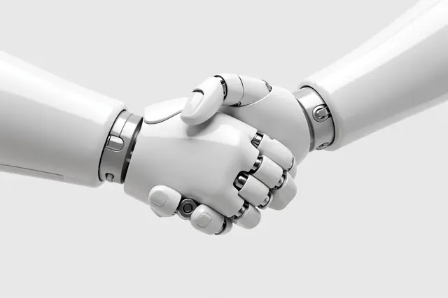 Two glossy white robot hands shake against a plain light gray background