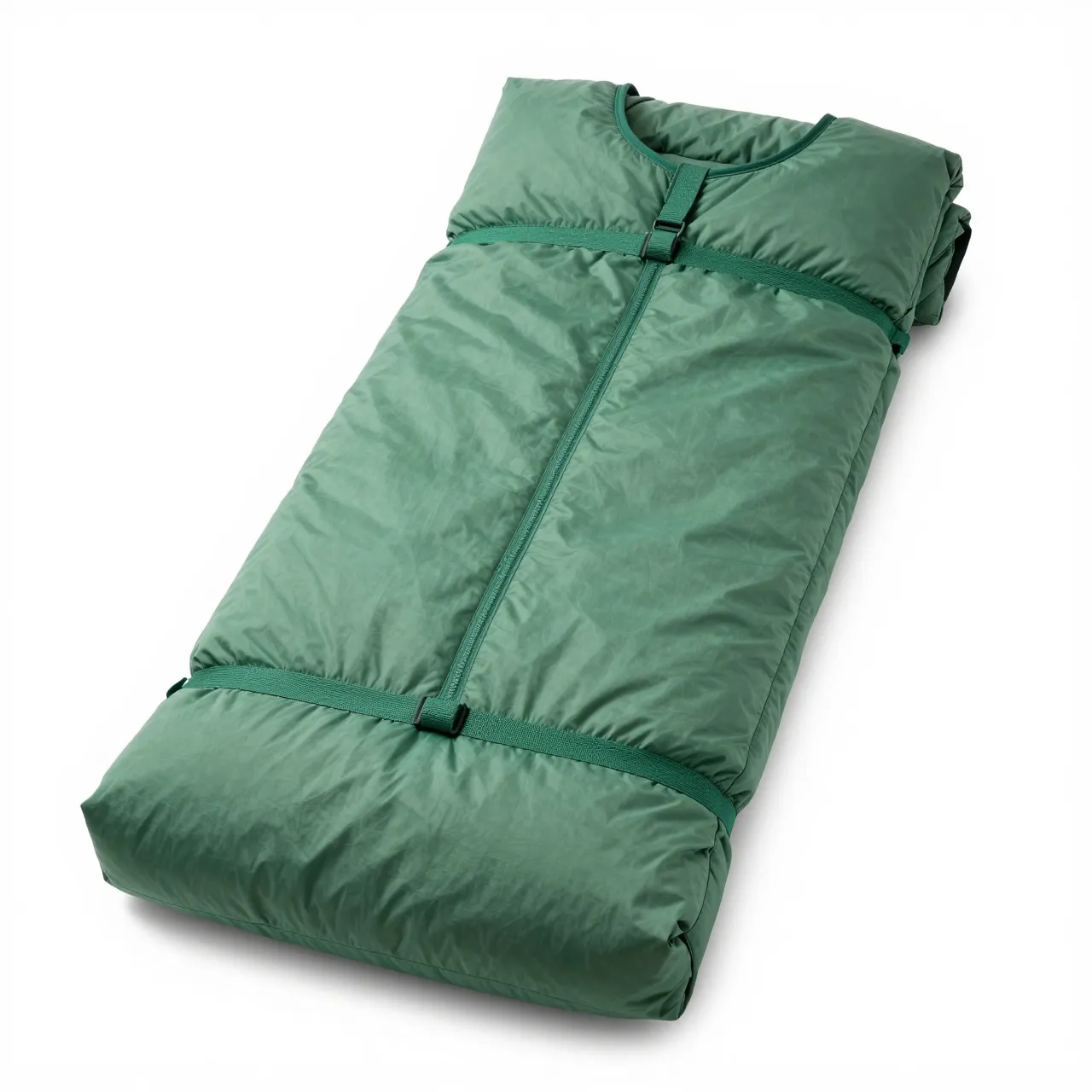 Compressed plain green sleeping bag with straps and zipper, isolated on a pure white studio background