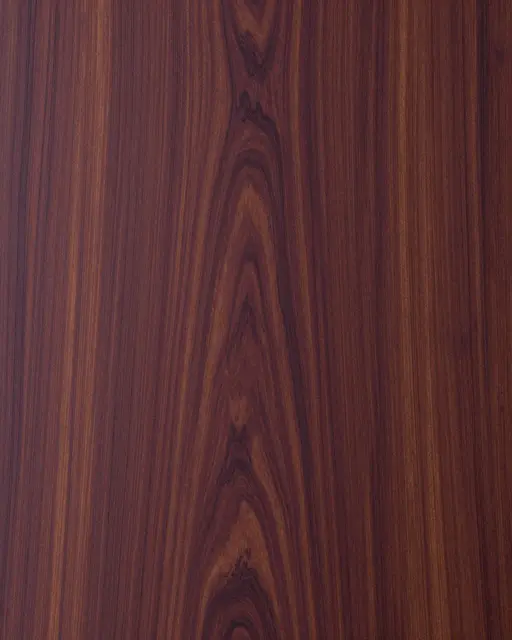 Full frame flat lay close-up of purplish brown rosewood with swirling dark grain lines